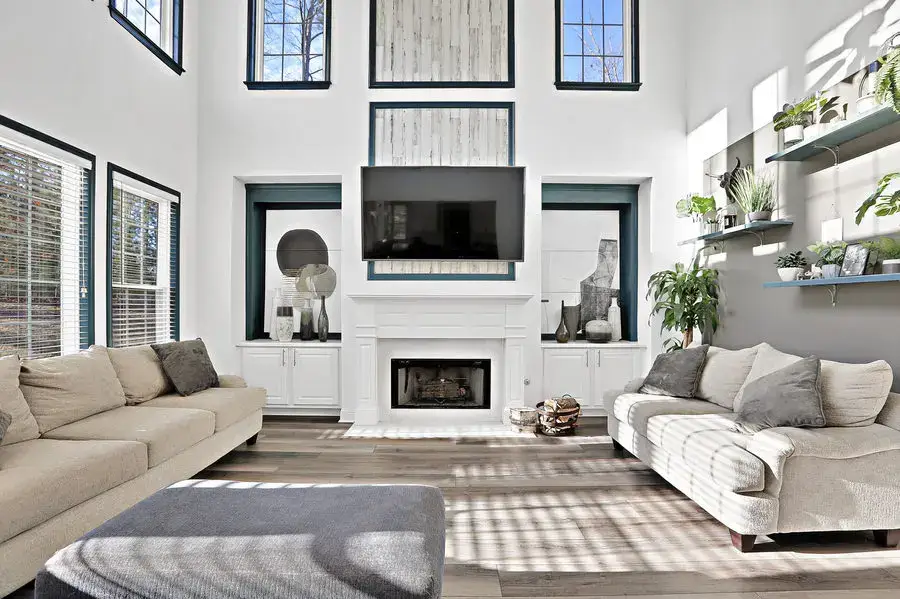 Parker living room with a double-height fireplace and large windows